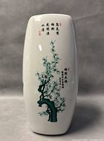 Front side of the vase with hand painted plum blossoms and Japanese calligraphy.