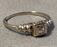 Oblique front view showing square bezel and diamond