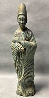 Front angled view of the 15-inch tall greenish resin Chinese official figurine showing detailed robes and headdress, holding feathers.