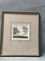 Full view of framed artwork with mat and gold wood frame