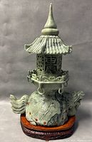Front view of jade pagoda on wooden stand