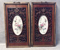 Full front view of both carved wood frames with inset oval porcelain plaques.