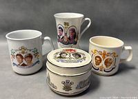 Front view of the group of three Royal Family mugs and one trinket box showing portraits of Prince Charles, Princess Diana, Prince Andrew, and Princess Sarah with decorative motifs