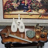 Overview of all nine decorative pieces displayed on wooden surface beneath framed artwork