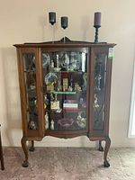 Front view of entire cabinet with decorations on shelves