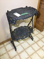 Front angle view of the stand showing two levels and scrollwork detailing.