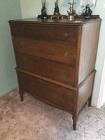 Front view of a wooden four drawer chest dresser showing drawer handles and wood finish.