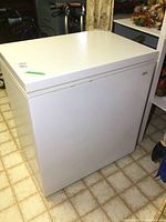 Kenmore chest freezer in white, closed lid, showing general exterior condition