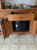 Sony black stereo system model LBT-A295 with 5-disc CD changer inside a wooden cabinet with doors open