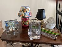 Overview of all candleholders and candles arranged on a wooden table showing variety and styles