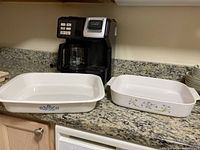 Both Corning Ware baking dishes in front; Hamilton Beach FlexBrew coffee maker behind