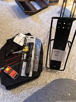 Photo showing bike panier rack, Topeak bike pump (new, in packaging), black fabric panier bag, tire repair kit.