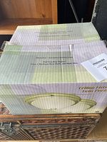Box of ceiling fixture light showing branding and bulb information.