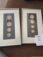 Two framed silver coin sets with mats and silver frames shown side by side.