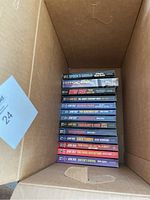 Stack of 13 books including Star Trek novels and Target Antarctica, showing spines and titles.