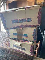 Three stacked Duracolor boxes featuring vintage design and branding.