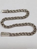 Full view of the 8-inch silver chain bracelet showing chain links and end caps.