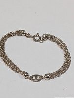 Full view of the sterling silver multi-strand chain bracelet with polished spherical beads and spring-ring clasp.
