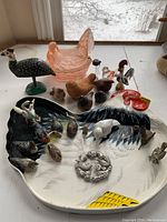The entire collection arranged on a surface with various bird and chicken figurines and the large painted chicken tray visible.