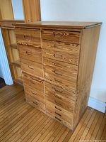 Front angled view of both solid wood chest units showing the drawer layout and wood grain texture.