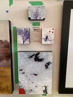 Four original wood block paintings mounted on a wall showing bird and tree motifs, indicated sizes 3x4 and 9x12 inches.