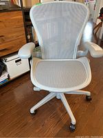 Front view showing mesh seat, back, armrests, base