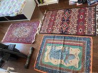 Three scatter rugs displayed on a wood floor - various patterns and colors
