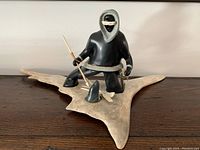 Front view of full lot showing hunter figure on antler base with accessories