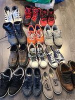 Full lot of 14 pairs of men's shoes with a variety of colors and styles. Shoes show use and require cleaning.