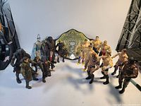 Middle Earth and WWE figures posed facing each other with championship belt in center