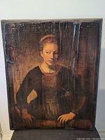 Close up front image of the painting on wood showing texture, subject and scratches