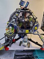 Front view of the Playmobil Space Station dome with solar panels and figure on the loading platform; shuttle craft beneath.