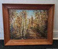 Frontal image of the signed oil painting showing autumn scene with birch trees, pathway, and oak wood frame.