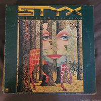 Front cover of Styx - The Grand Illusion vinyl record, showing colorful surreal artwork.