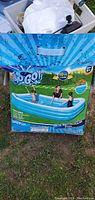 Box showing brand, dimensions, and image of the inflatable pool in use with family outdoors.
