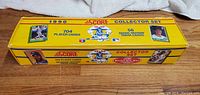 Closed yellow 1990 Score collector box featuring baseball player photos and listing 704 player cards and 56 trivia cards.