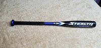 Blue and black Easton Stealth youth baseball bat laying flat showing full length and branding.