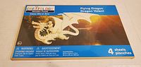 Box showing the front with brand 'Creatology' and label 'Flying Dragon Wooden Puzzle', indicating 4 sheets included.