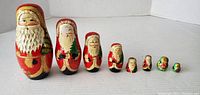 Seven Santa-themed nesting dolls arranged in size order from largest to smallest