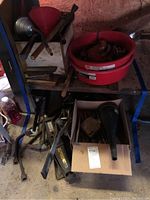 Image showing funnels, oil pans, crow bars, and assorted tools on a shelf and floor