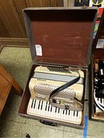 Piano accordion seated in open carrying case