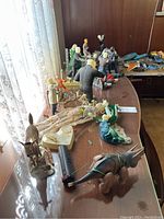 Overview of assorted monster models and dioramas on table
