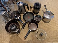 Overview of all items including electric kettle, juicer, can opener, pots, pans, steamer basket