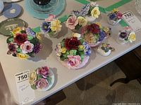 Overview of 11 fine bone china flower bouquets displayed on a table, showing different sizes and colorful floral arrangements.