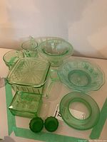 Overall view of all ten green glass pieces on table