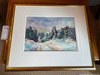 Full view of framed watercolor painting depicting a snowy forest path with trees and moody sky.