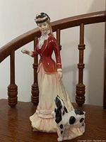 Front angle of Royal Doulton Sarah figurine with dog and detailed view of clothing and posture.