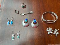 Lot overview photo showing all jewelry pieces on wooden surface