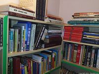 Books on shelves showing variety of educational and reference titles including language learning and encyclopedias
