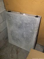 Front view of the folded 6 ft resin folding table showing textured gray surface with wear marks.